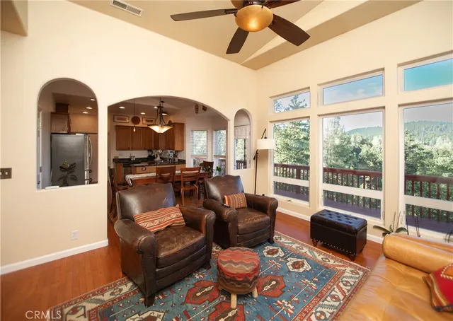 a living room with furniture and a floor to ceiling window