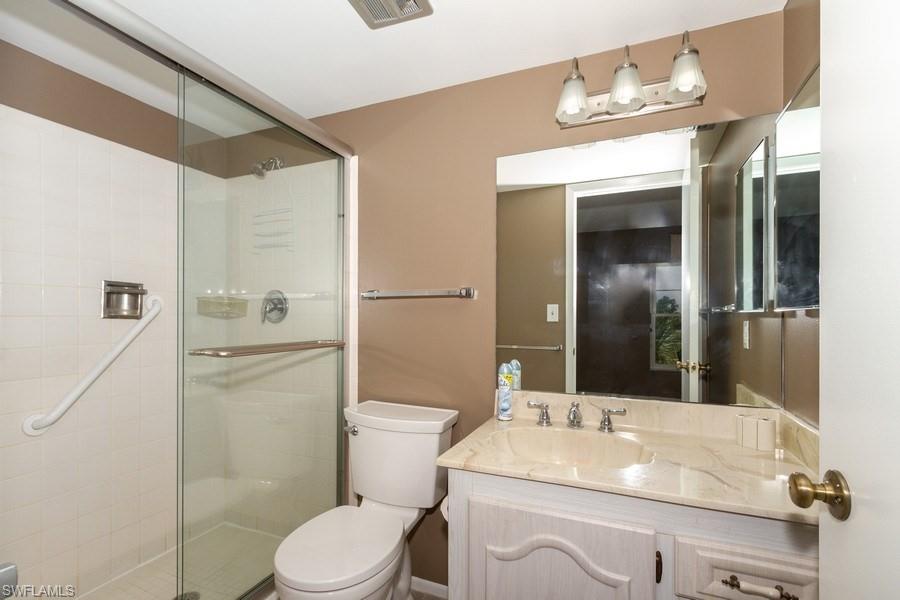 200 Pebble Beach Boulevard, Unit D402 Naples, FL 34113 - Photo 9 of 14 a bathroom with a sink toilet and shower