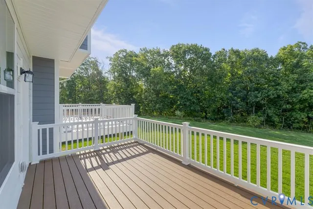 a view of balcony with wooden floor and fence