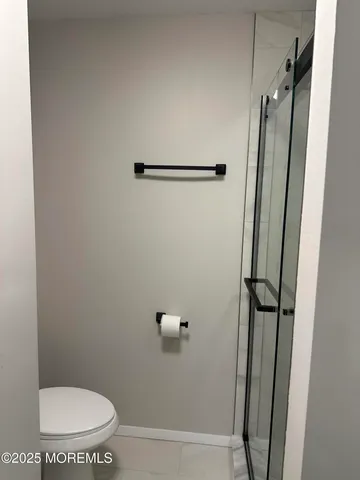 a bathroom with a toilet and a shower