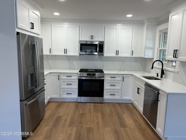 a kitchen with a refrigerator stove and sink
