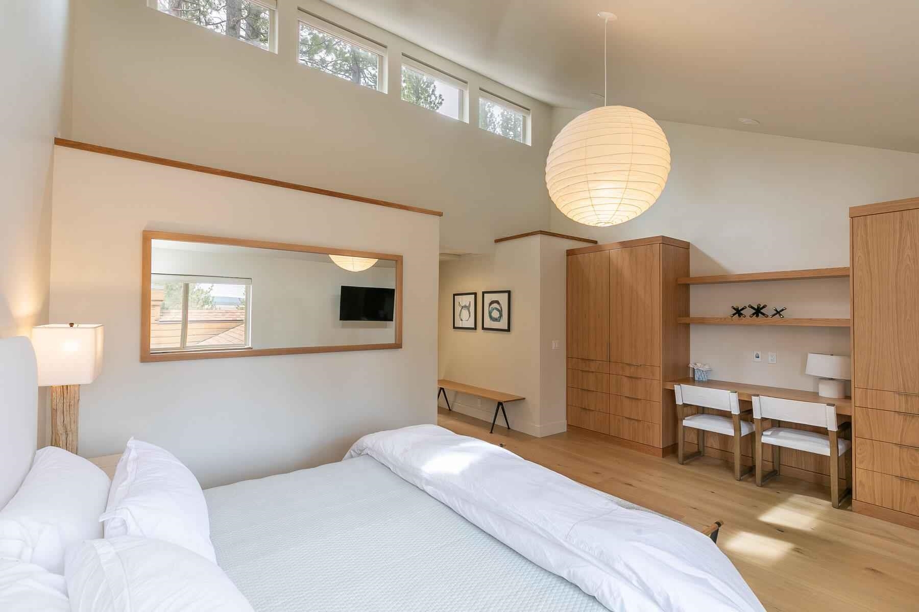 237 Basque Drive Truckee, CA 96161 - Photo 17 of 23 a bedroom with a bed and a chandelier