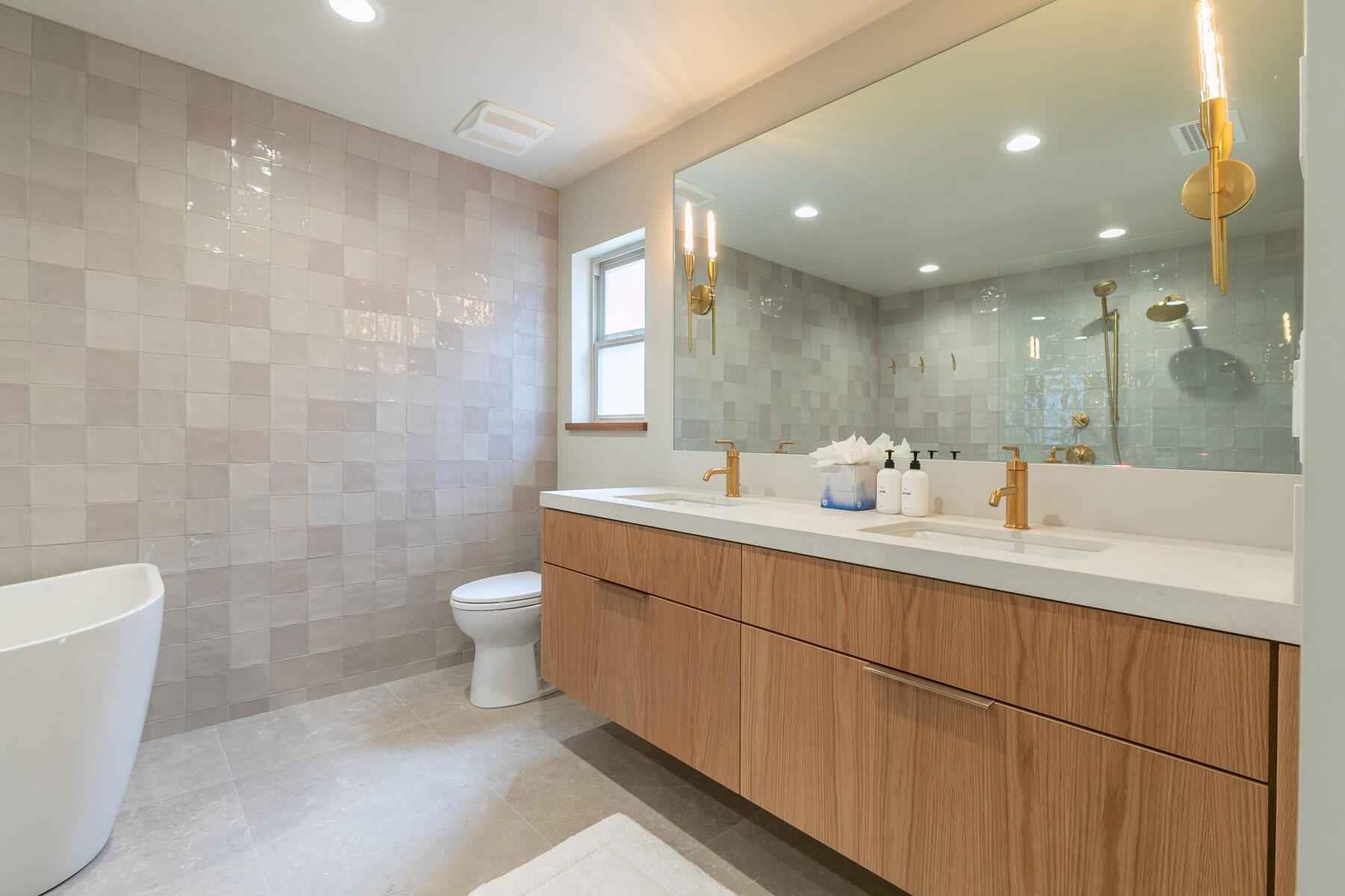 237 Basque Drive Truckee, CA 96161 - Photo 19 of 23 a bathroom with a double vanity sink a toilet and a bathtub