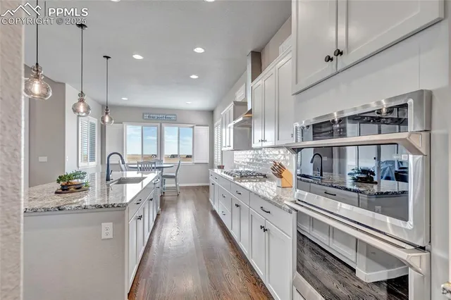 a kitchen with stainless steel appliances a sink stove and cabinets