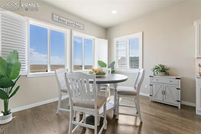 a view of a dining room with furniture window and wooden floor