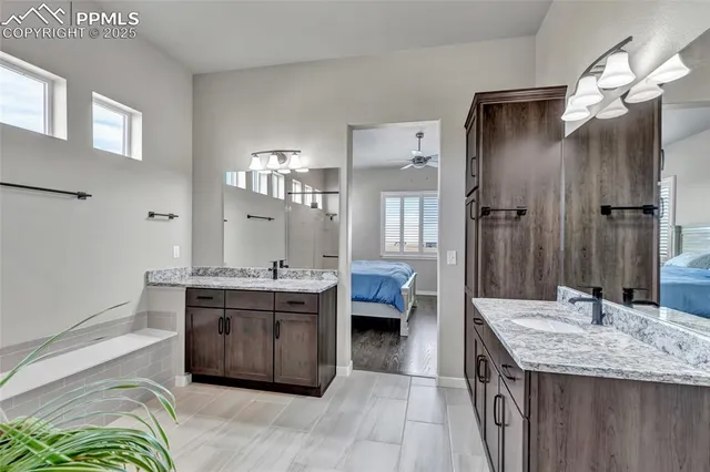 a spacious bathroom with a granite countertop sink and a mirror