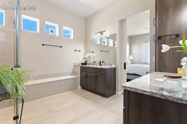 a bathroom with a granite countertop sink a toilet and bathtub