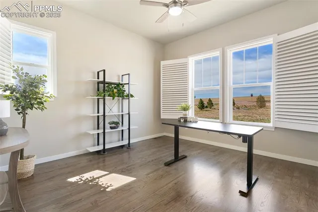 a view of a livingroom with wooden floor and furniture