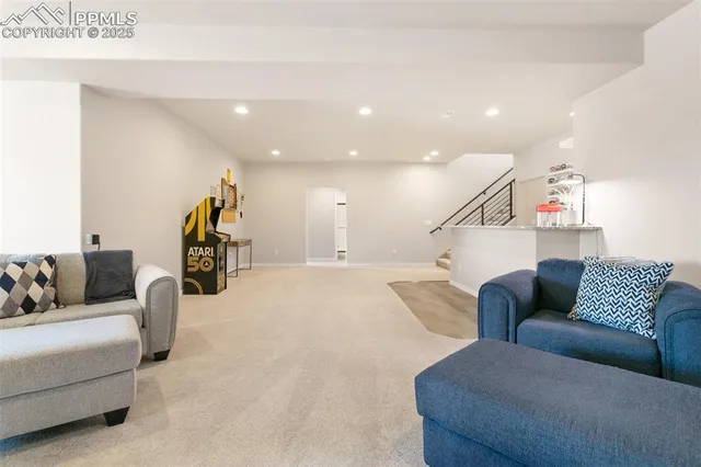 a living room with furniture and a ceiling fan