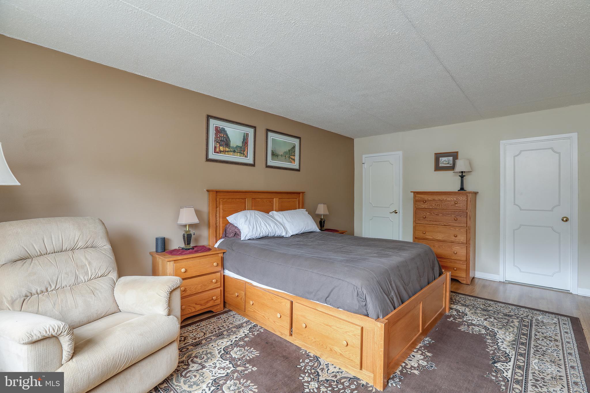 860 Lower Ferry Road, Unit 2C Ewing, NJ 08628 - Photo 16 of 19 a bedroom with a bed and couch