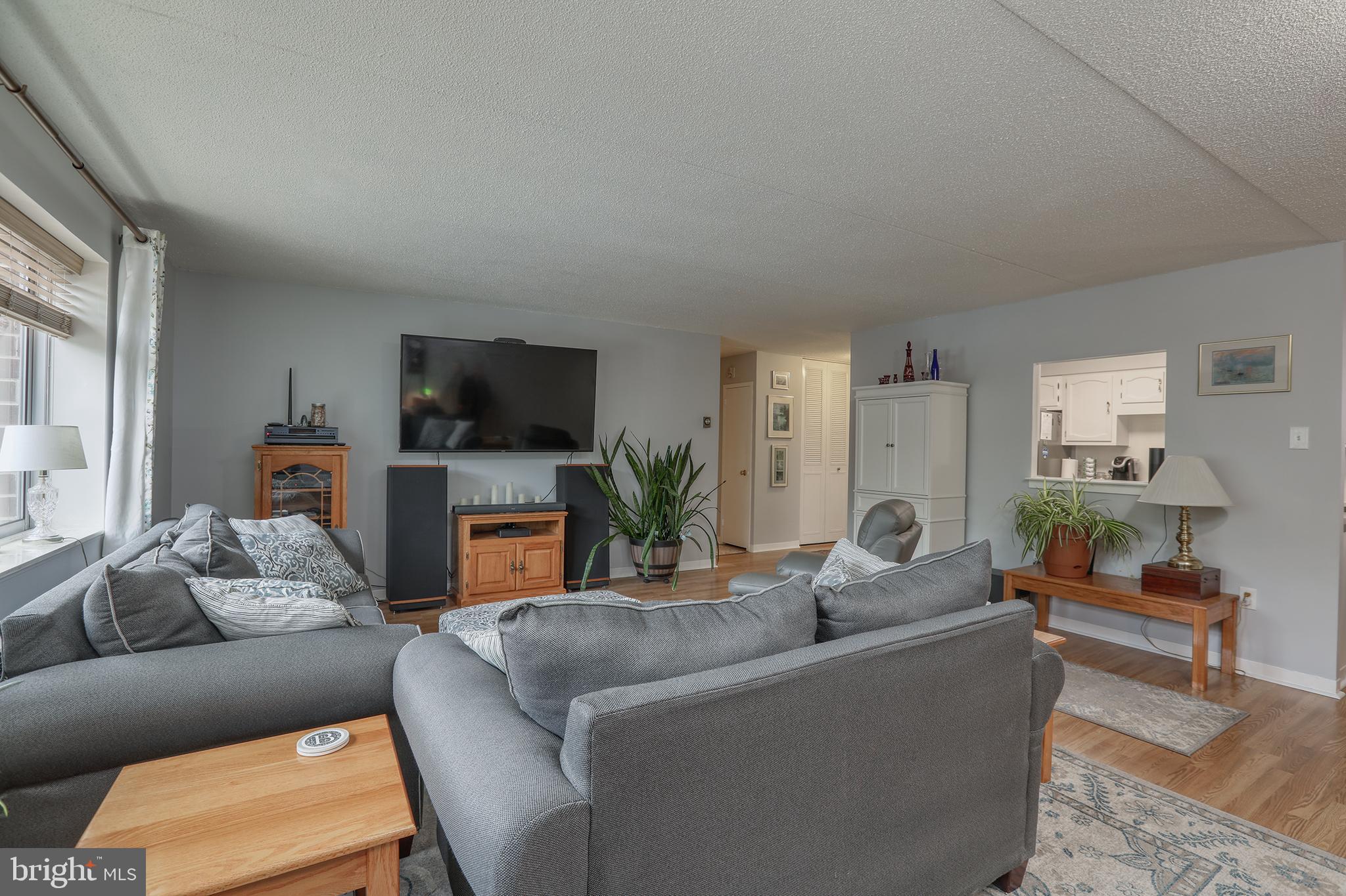 860 Lower Ferry Road, Unit 2C Ewing, NJ 08628 - Photo 3 of 19 a living room with furniture a flat screen tv and a fireplace