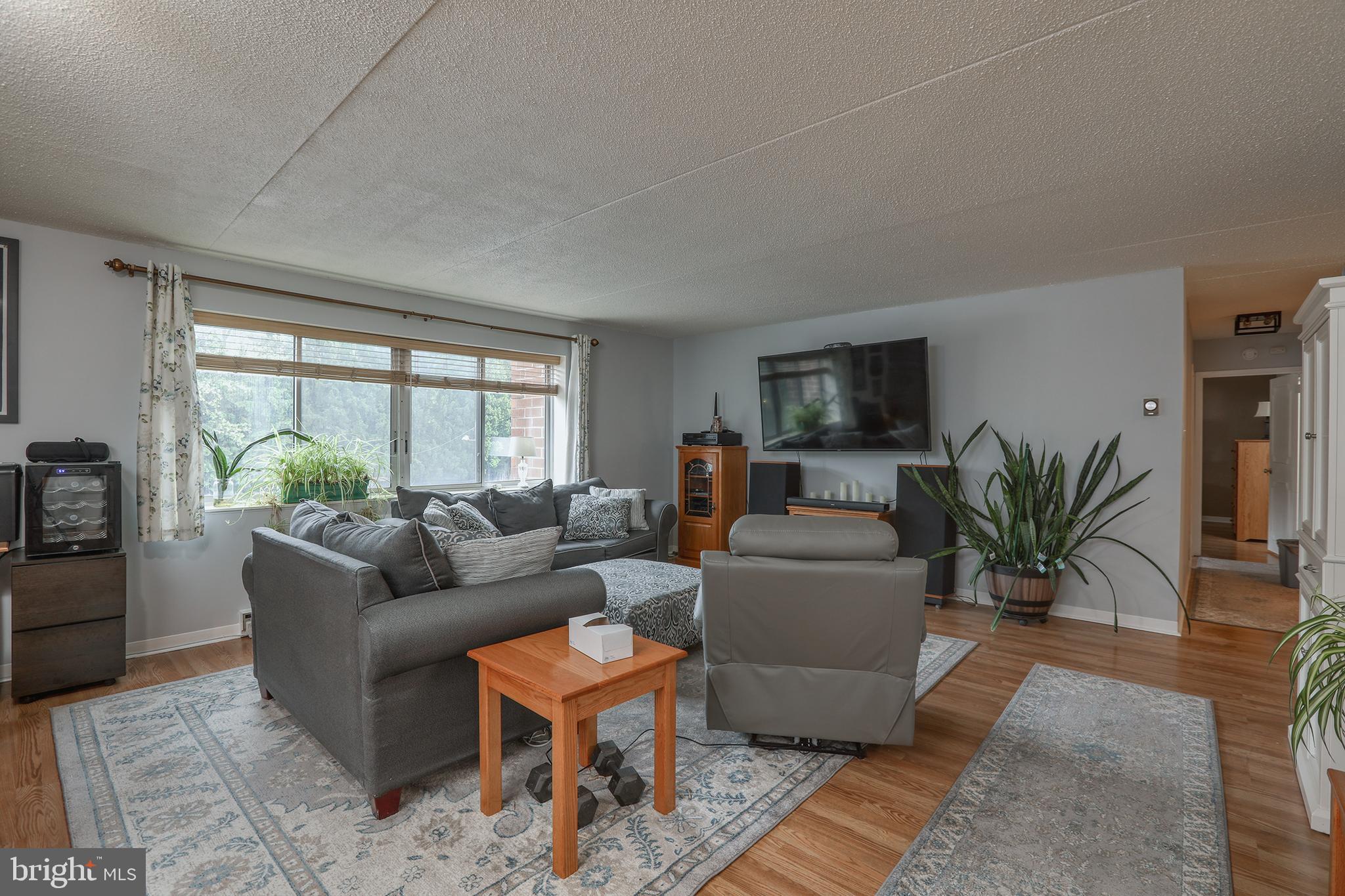860 Lower Ferry Road, Unit 2C Ewing, NJ 08628 - Photo 4 of 19 a living room with furniture and a large window