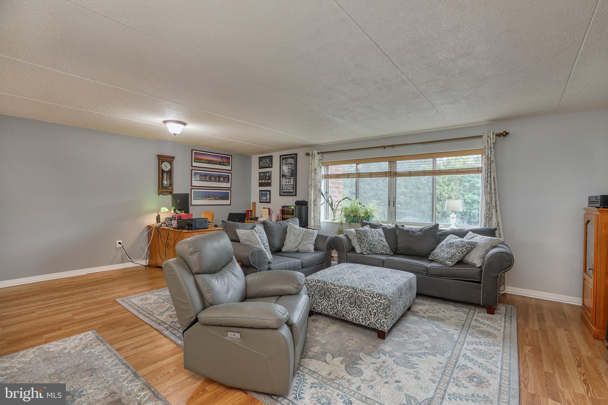 860 Lower Ferry Road, Unit 2C Ewing, NJ 08628 - Photo 5 of 19 a living room with furniture and a large window