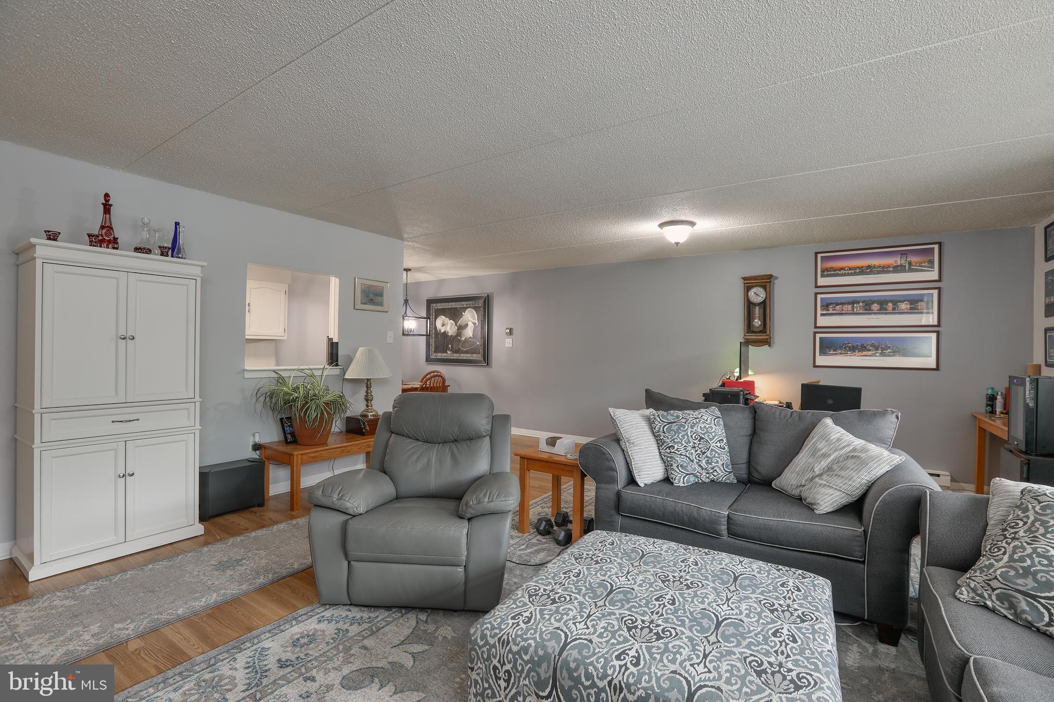860 Lower Ferry Road, Unit 2C Ewing, NJ 08628 - Photo 7 of 19 a living room with furniture and wooden floor