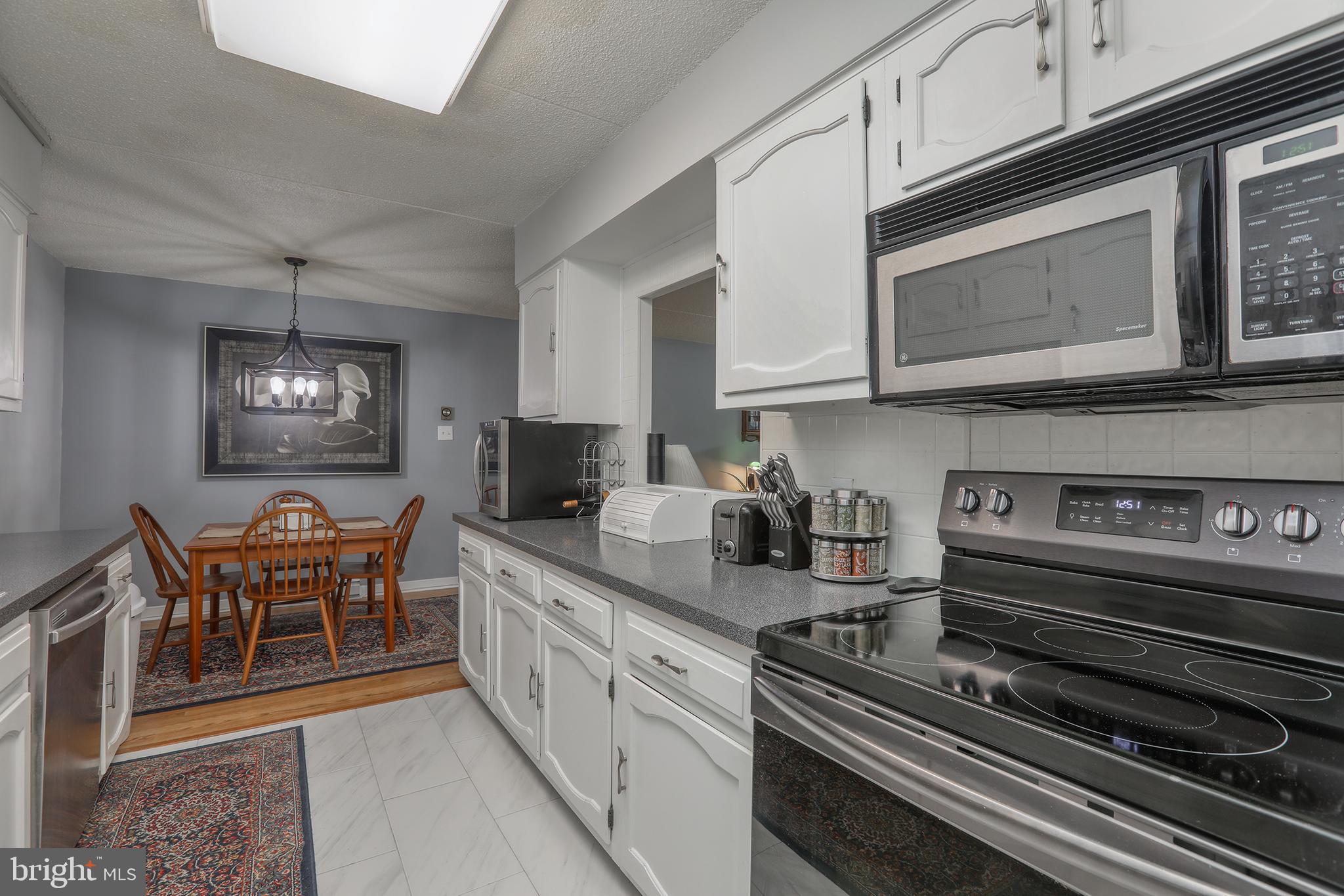 860 Lower Ferry Road, Unit 2C Ewing, NJ 08628 - Photo 10 of 19 a kitchen with stainless steel appliances granite countertop a stove and cabinets