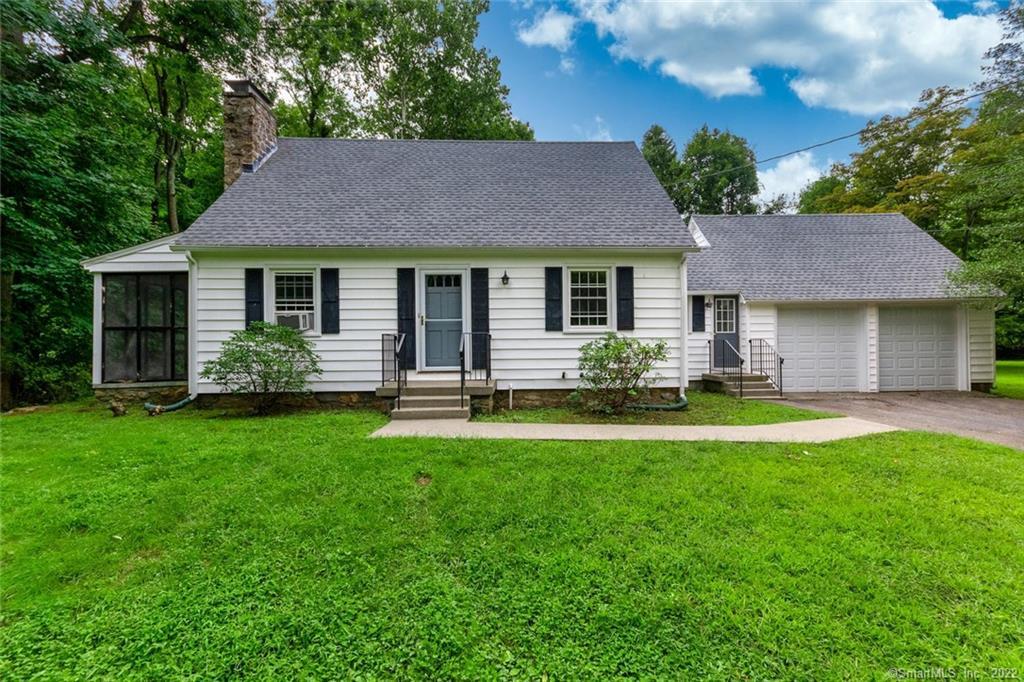 519 Booth Hill Road Trumbull, CT 06611 - Photo 1 of 1 a front view of a house with a yard and green space