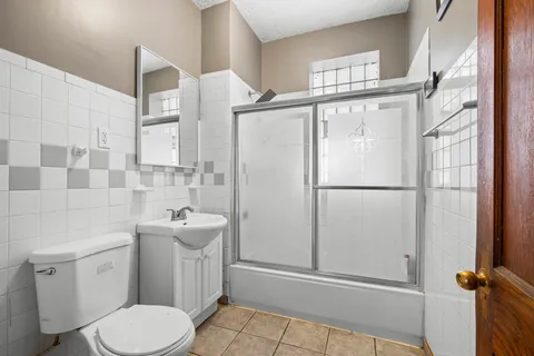 a white toilet sitting next to a bathroom sink