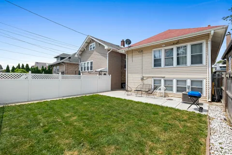 an aerial view of residential houses with outdoor space and parking
