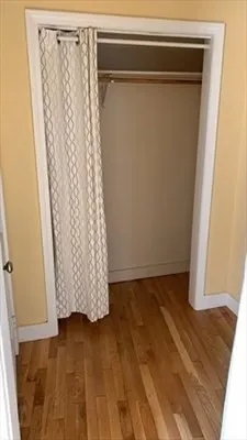a view of walk in closet with wooden floor