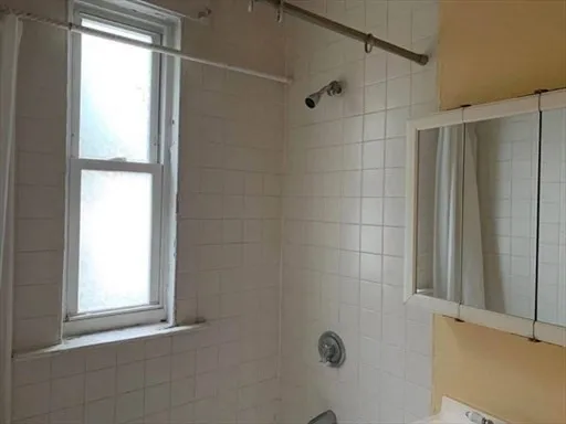 a bathroom with a window and shower