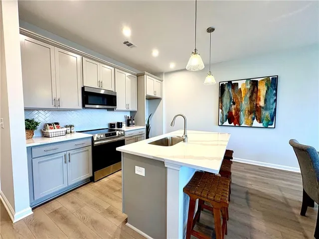 a kitchen with a sink a center island and furniture