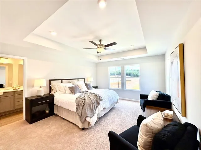 a bedroom with a bed and painting on the wall