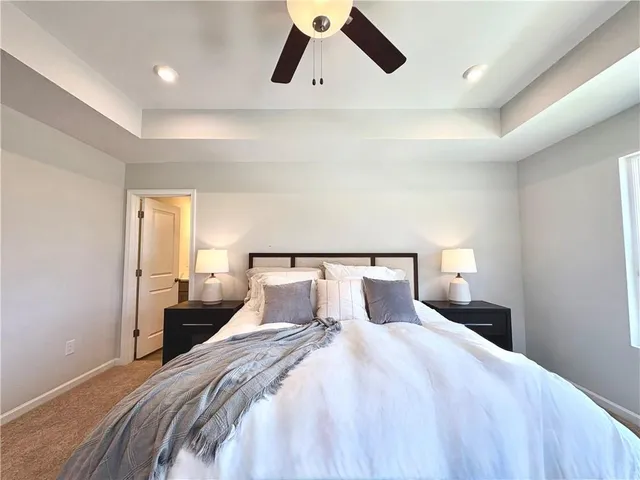 a bedroom with a bed couch and window