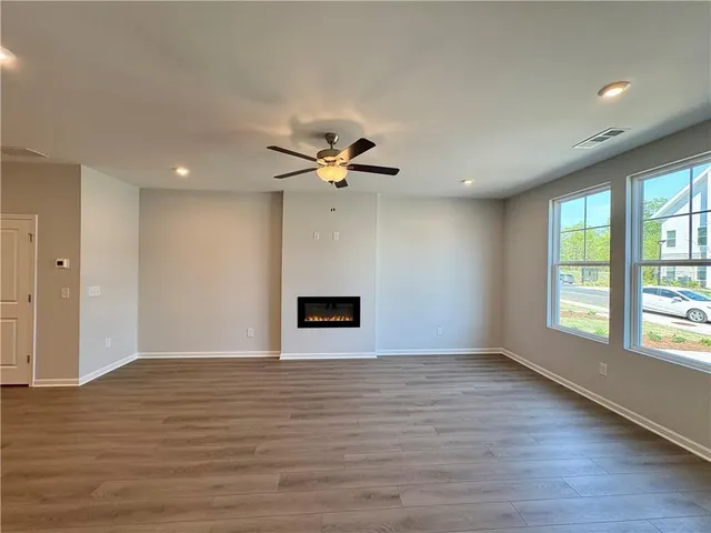 a kitchen with kitchen island a stove a counter space and wooden floors