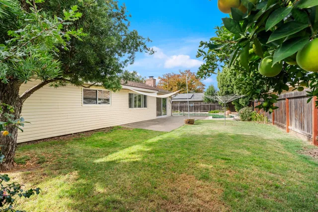 a view of small yard with wooden fence
