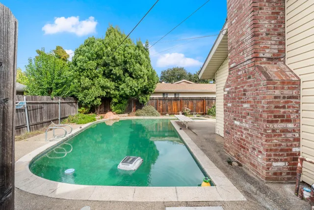 a view of a house with a yard and sitting area