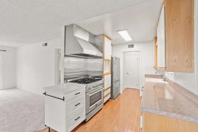 a kitchen with a stove and a sink