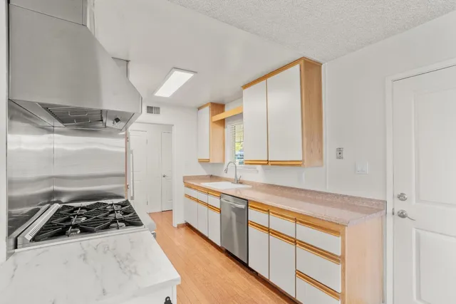 a kitchen with a stove and a refrigerator