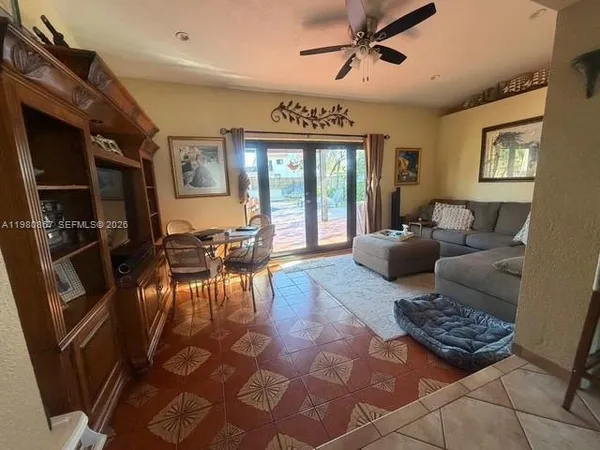 a living room with furniture and floor to ceiling windows