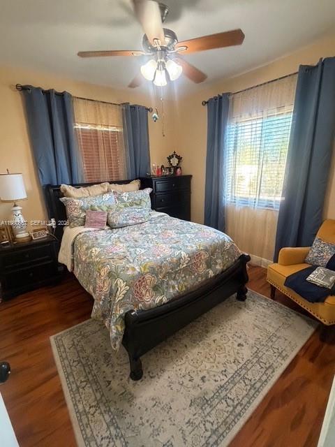 10720 Southwest 43rd Lane Miami, FL 33165 - Photo 15 of 16 a bedroom with a bed and dresser with wooden floor
