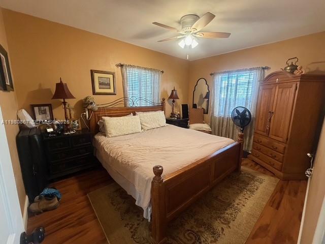 10720 Southwest 43rd Lane Miami, FL 33165 - Photo 16 of 16 a bedroom with a bed and wooden floor