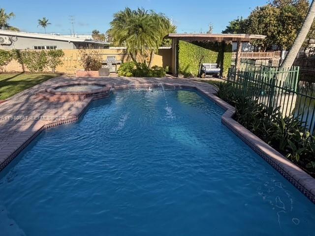 10720 Southwest 43rd Lane Miami, FL 33165 - Photo 2 of 16 a view of a swimming pool with a porch