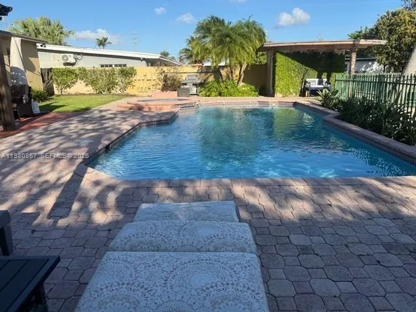 a view of a house with backyard and sitting area
