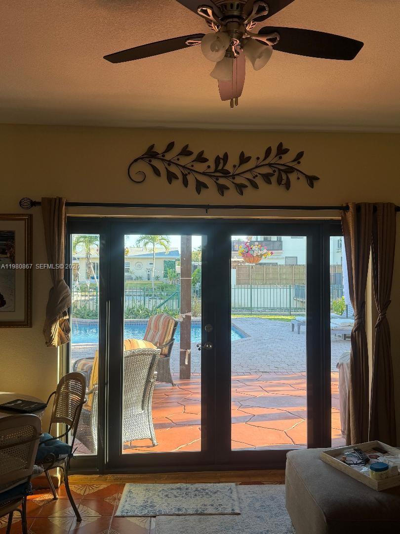 10720 Southwest 43rd Lane Miami, FL 33165 - Photo 10 of 16 a living room with furniture and a floor to ceiling window