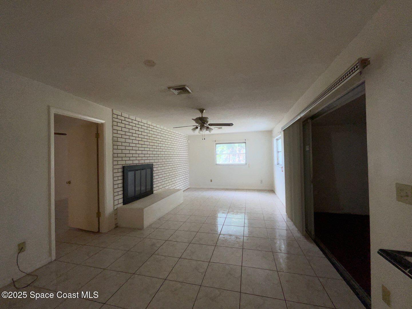 617 Walker Street Melbourne, FL 32901 - Photo 12 of 38 a view of a livingroom with a fireplace and window