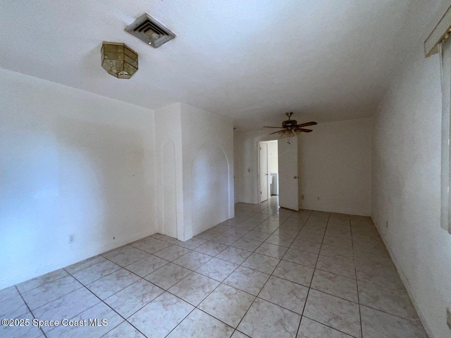 617 Walker Street Melbourne, FL 32901 - Photo 15 of 38 an empty room with water heater and wooden floor