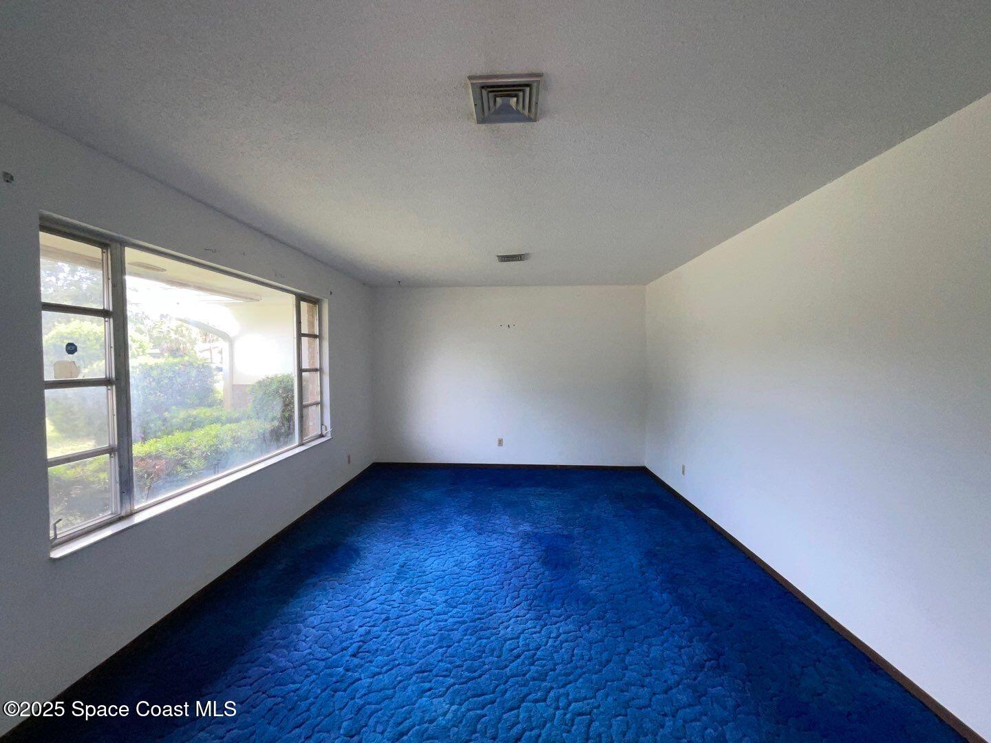617 Walker Street Melbourne, FL 32901 - Photo 19 of 38 an empty room with wooden floor and windows