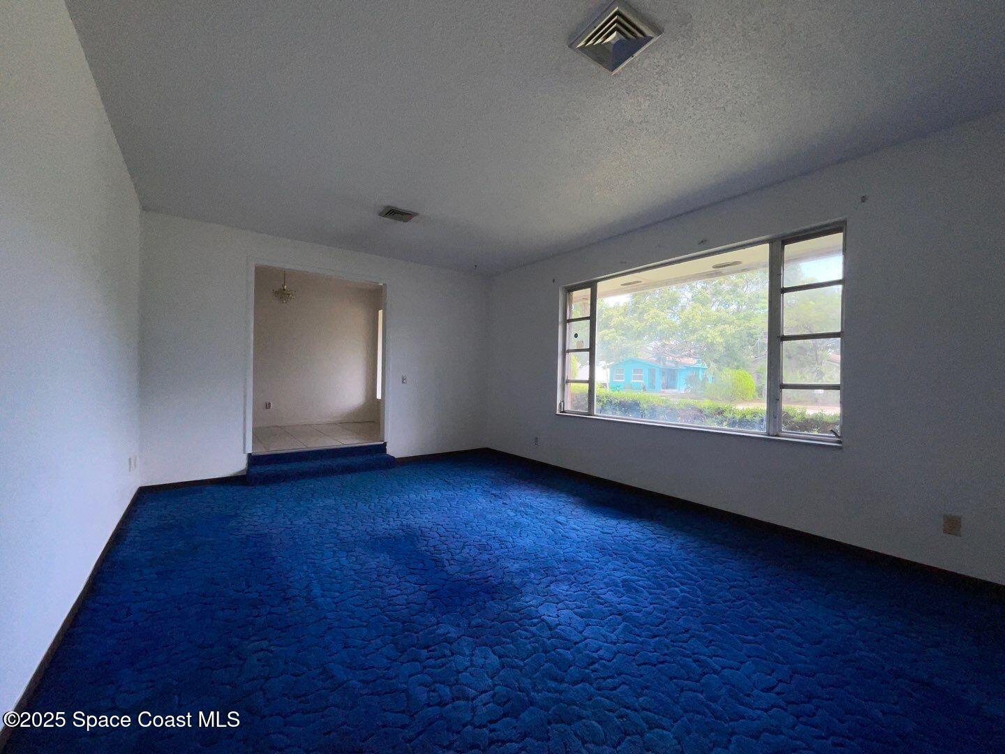 617 Walker Street Melbourne, FL 32901 - Photo 20 of 38 an empty room with wooden floor and windows