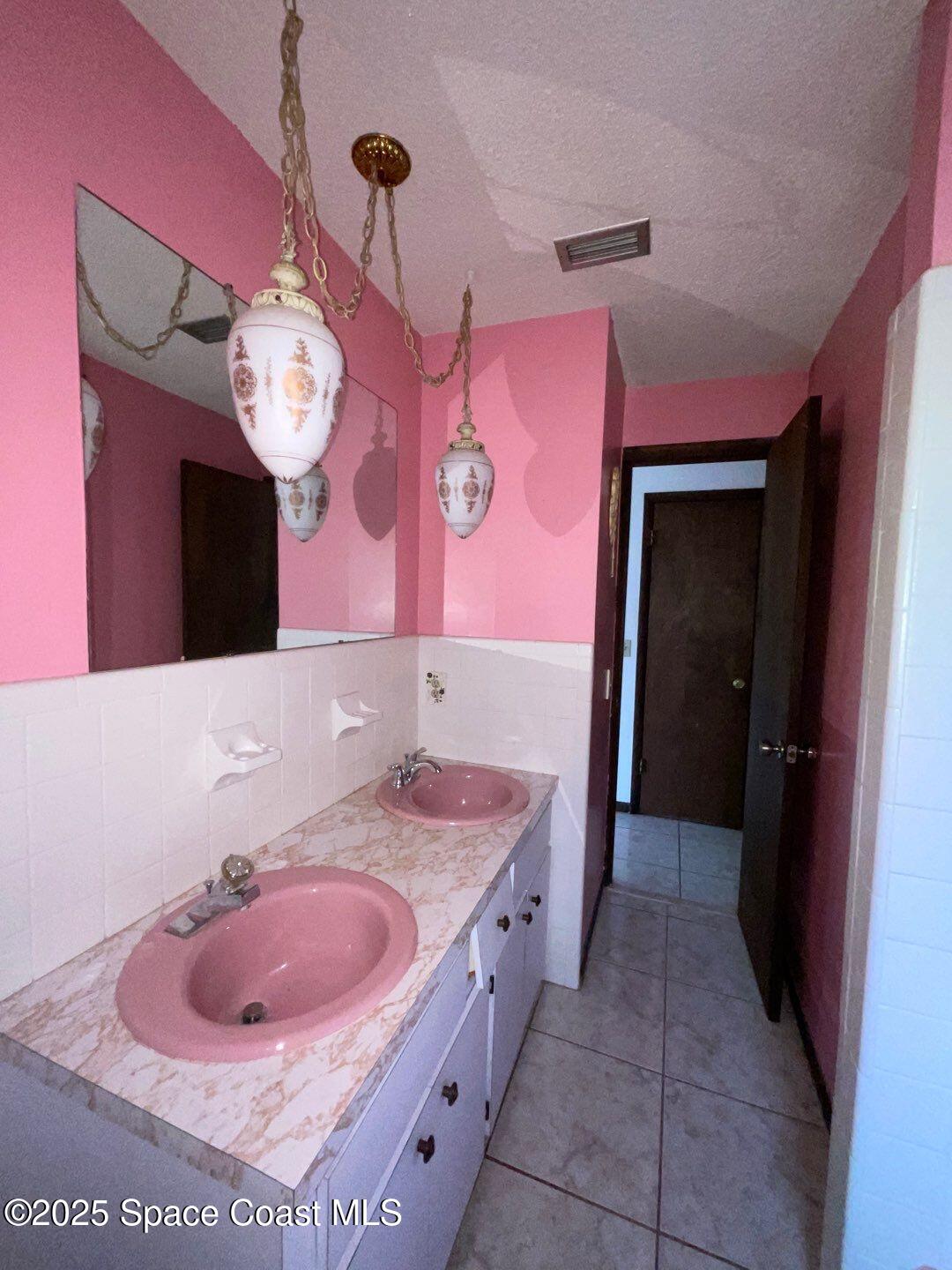 617 Walker Street Melbourne, FL 32901 - Photo 22 of 38 a bathroom with a sink and a mirror
