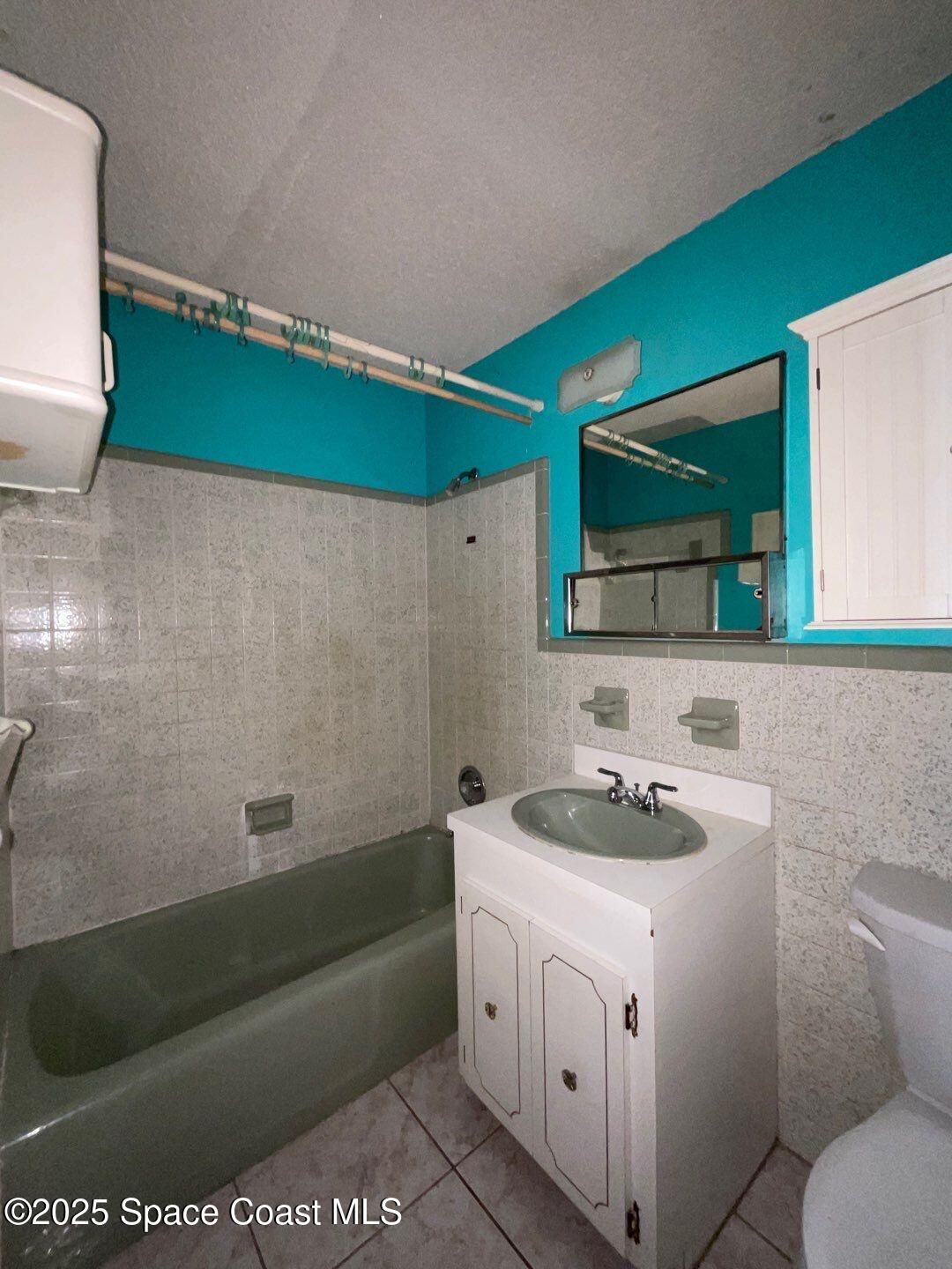 617 Walker Street Melbourne, FL 32901 - Photo 33 of 38 a bathroom with a sink and a mirror