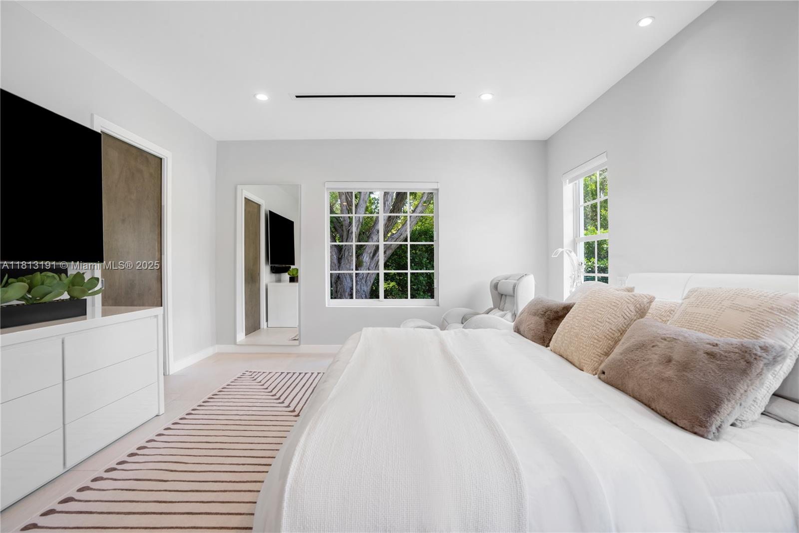 4380 Lake Road Miami, FL 33137 - Photo 24 of 41 a bedroom with a large bed and a flat tv screen