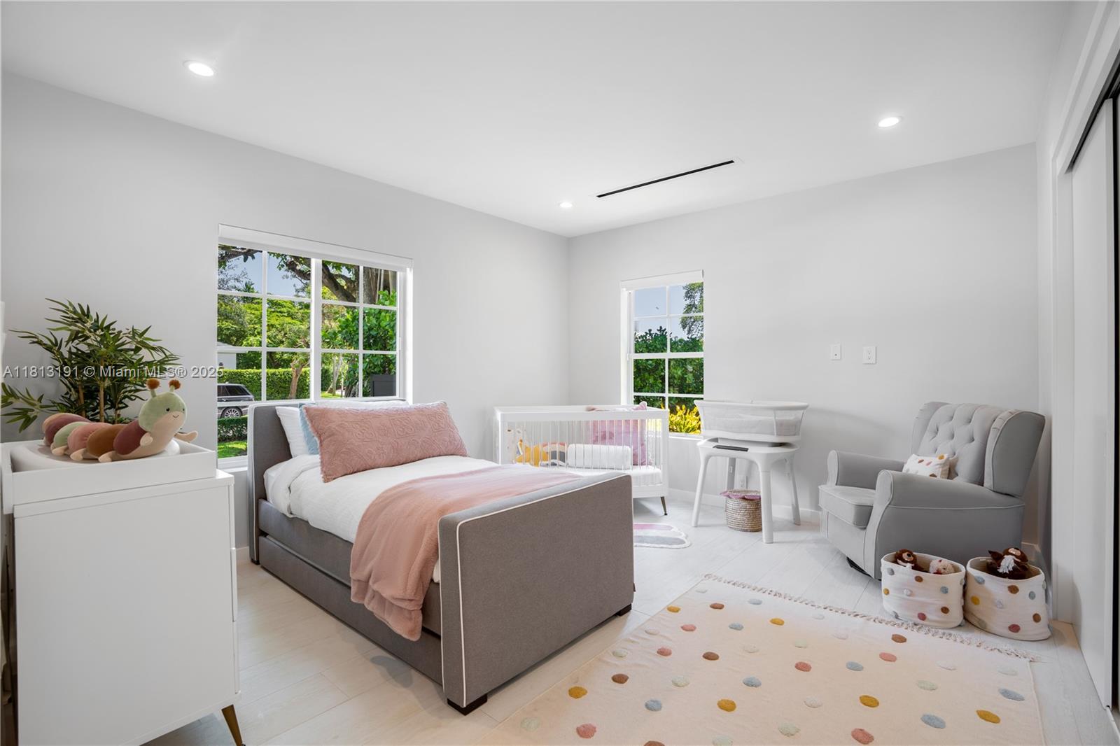 4380 Lake Road Miami, FL 33137 - Photo 26 of 41 a bedroom with a bed a couch and potted plant