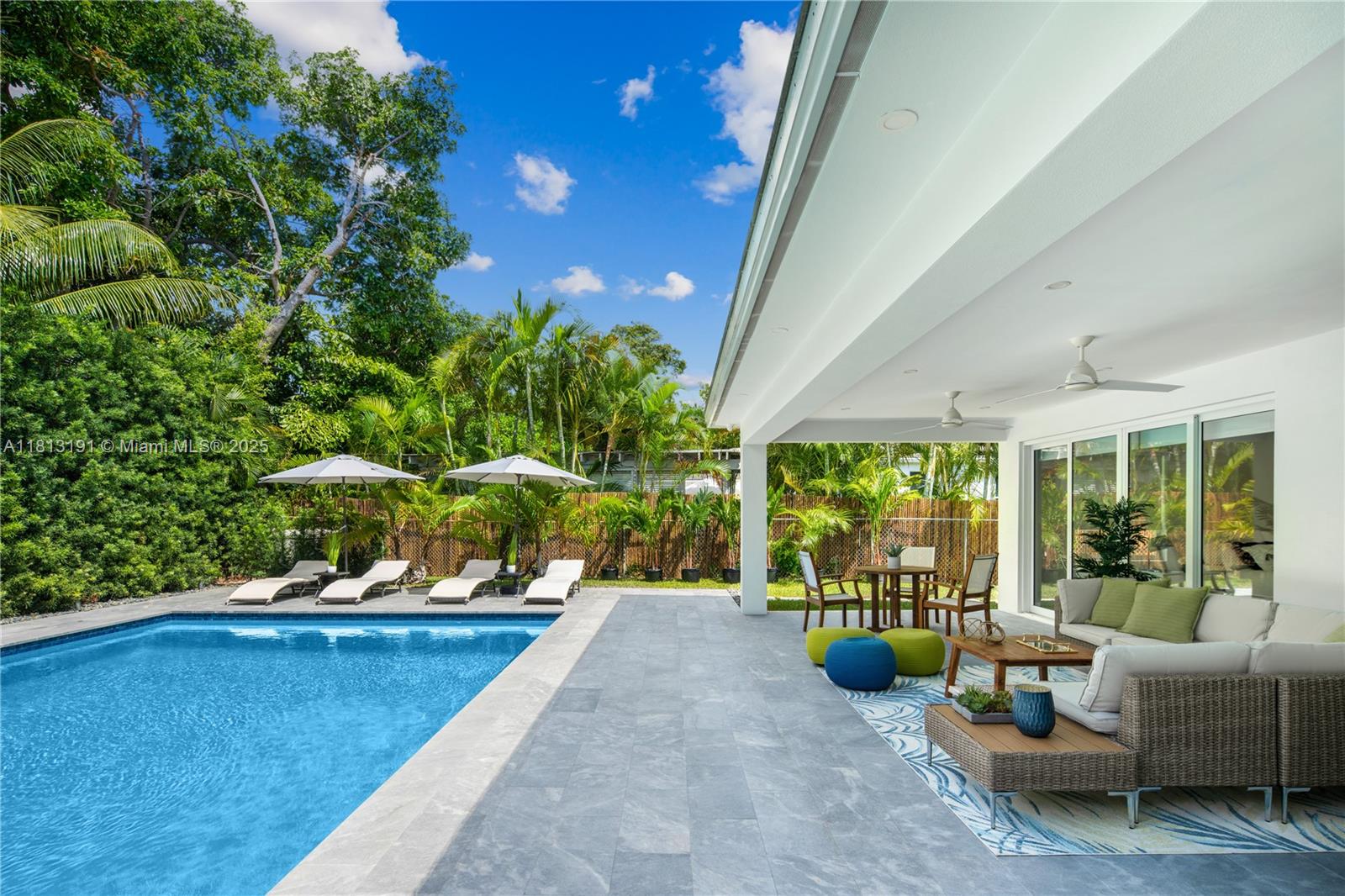4380 Lake Road Miami, FL 33137 - Photo 34 of 41 a swimming pool with potted plants and large tree