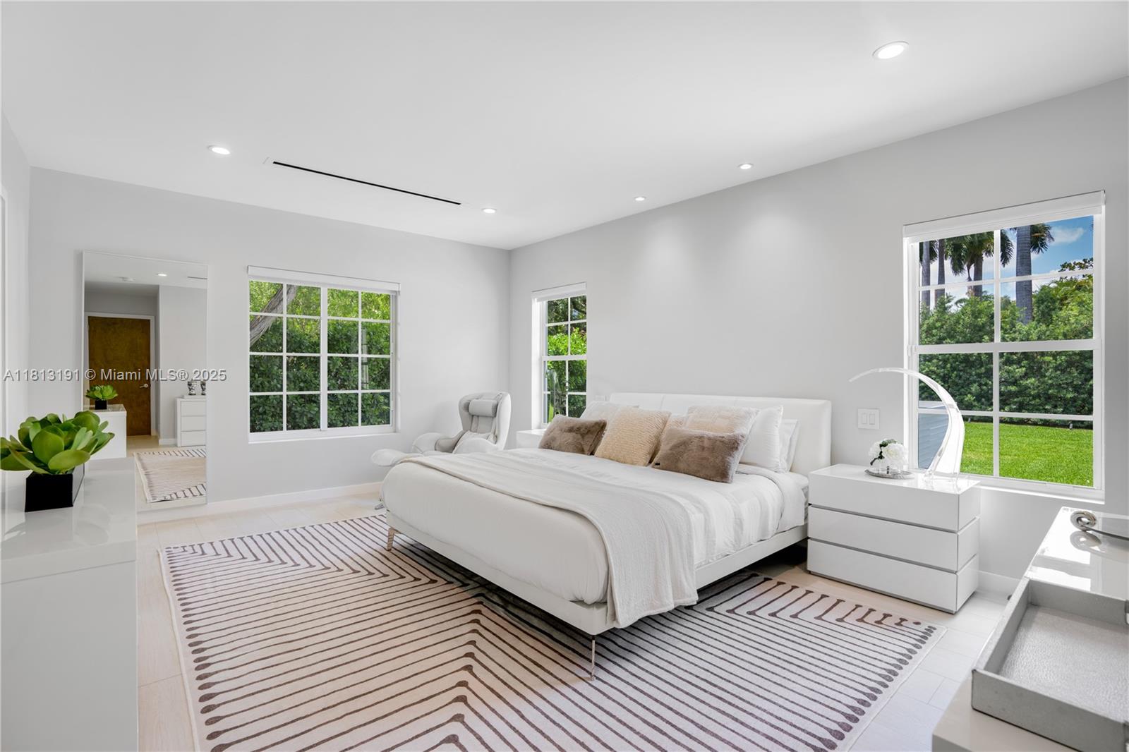 4380 Lake Road Miami, FL 33137 - Photo 9 of 41 a bedroom with a large bed and a large window