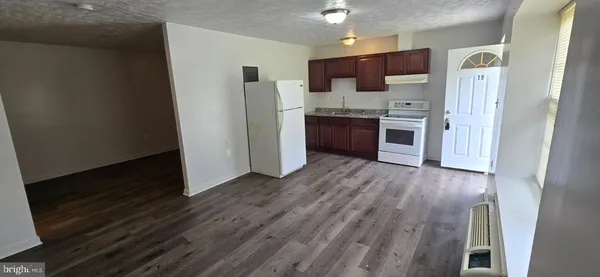 a kitchen with stainless steel appliances a refrigerator and a stove top oven