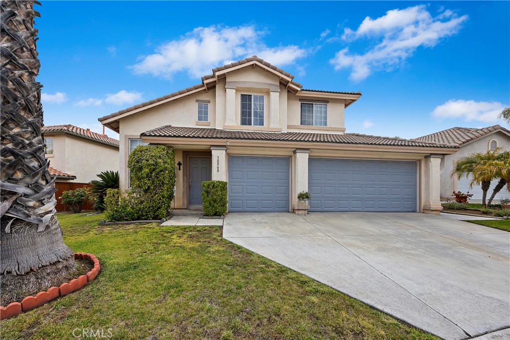 a front view of a house with a yard and garage